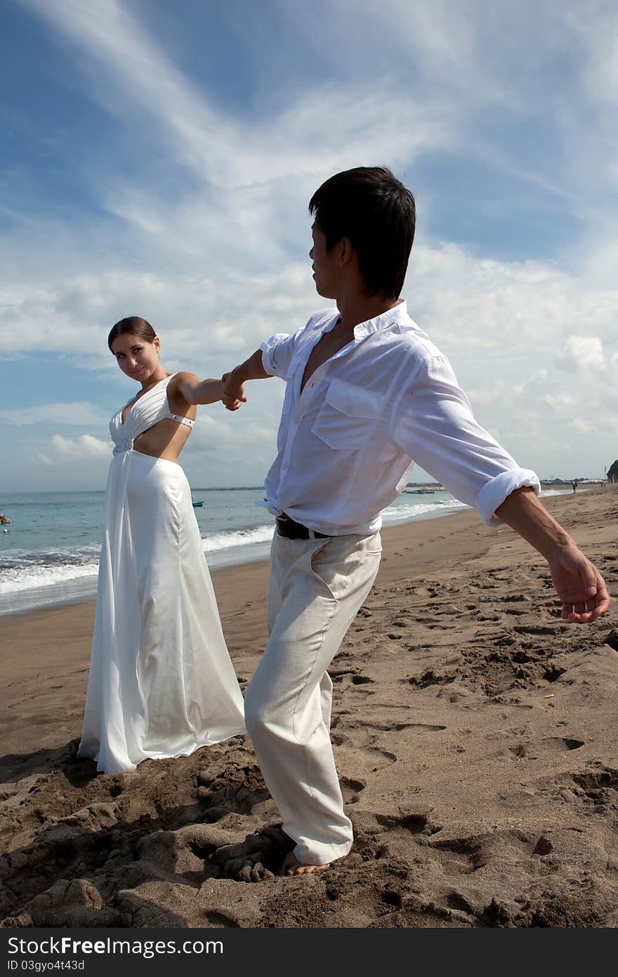 Romantic couple in white at the beach. Romantic couple in white at the beach