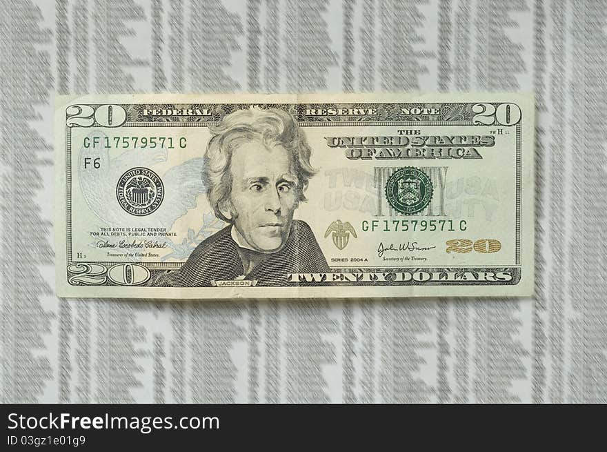 Twenty dollar bill with picture of Jackson with a crazy face, on the stock market paper as a background. Twenty dollar bill with picture of Jackson with a crazy face, on the stock market paper as a background.