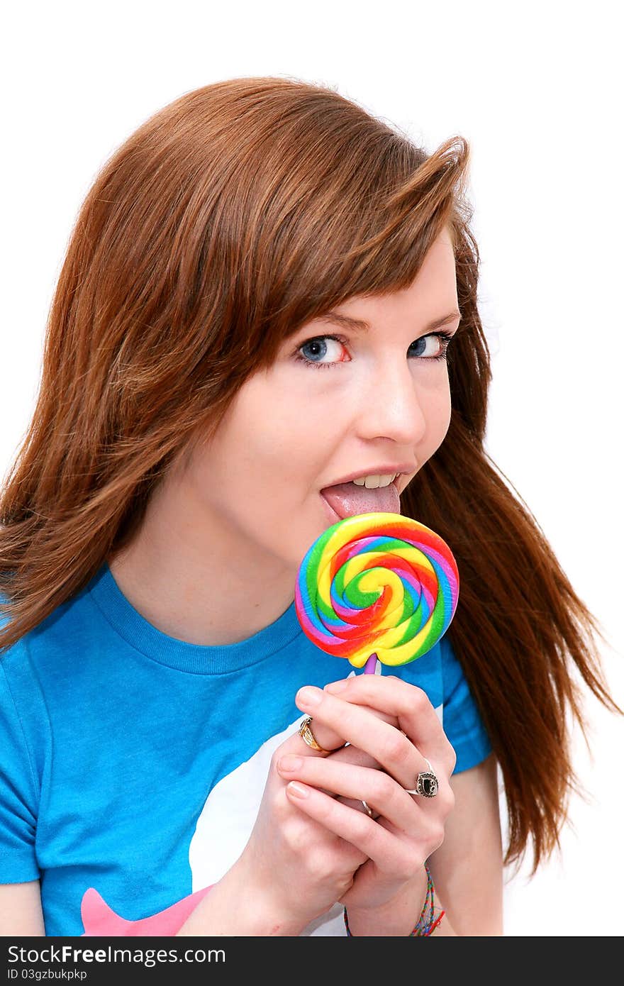 Teen girl with colorful lollipop on a white background. Teen girl with colorful lollipop on a white background