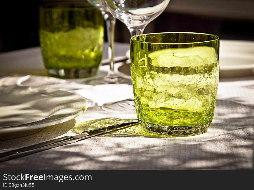 Close-up on glasses on a table set in an outdoors restaurant. Close-up on glasses on a table set in an outdoors restaurant.