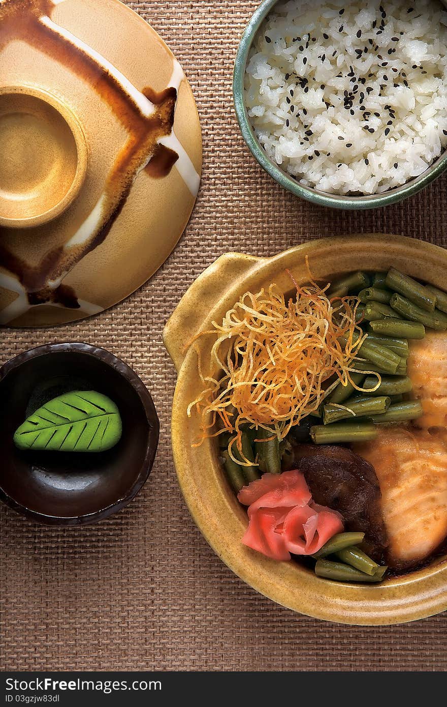 Hot pot with vegetables, fish and a bowl of rice. Hot pot with vegetables, fish and a bowl of rice