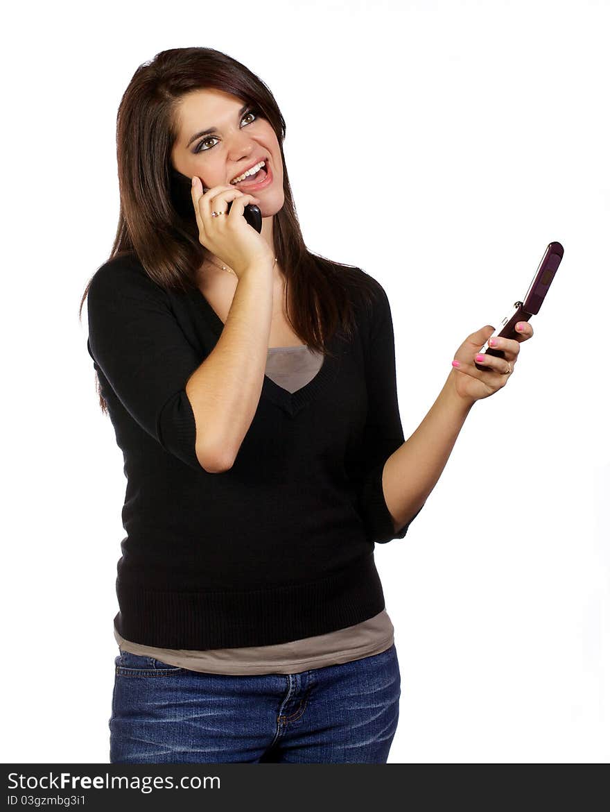 Young woman on her cell phones seeming to communicate in two conversations