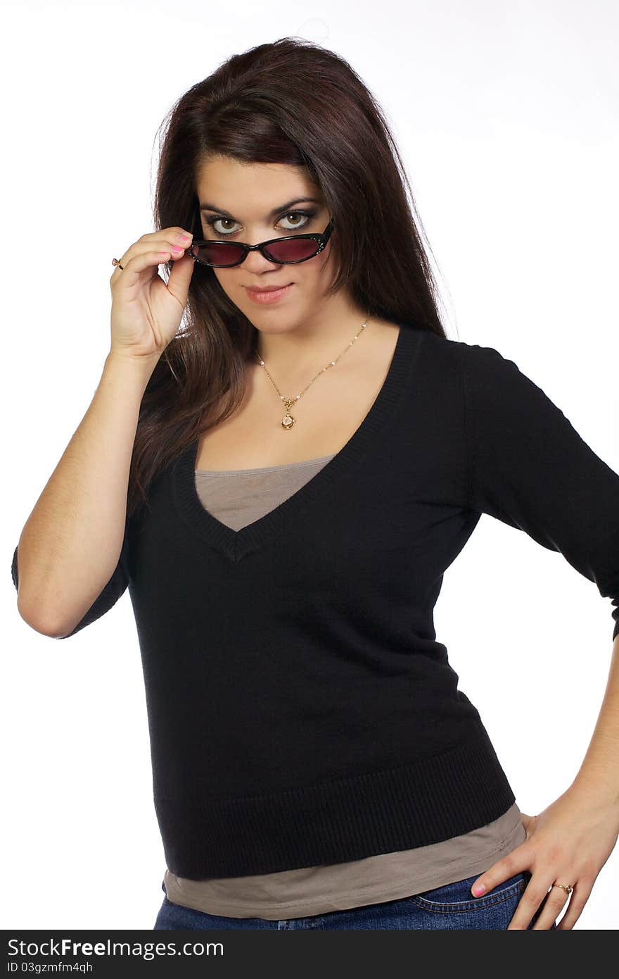 Young woman looking smart as she looks over her sun glasses. Young woman looking smart as she looks over her sun glasses