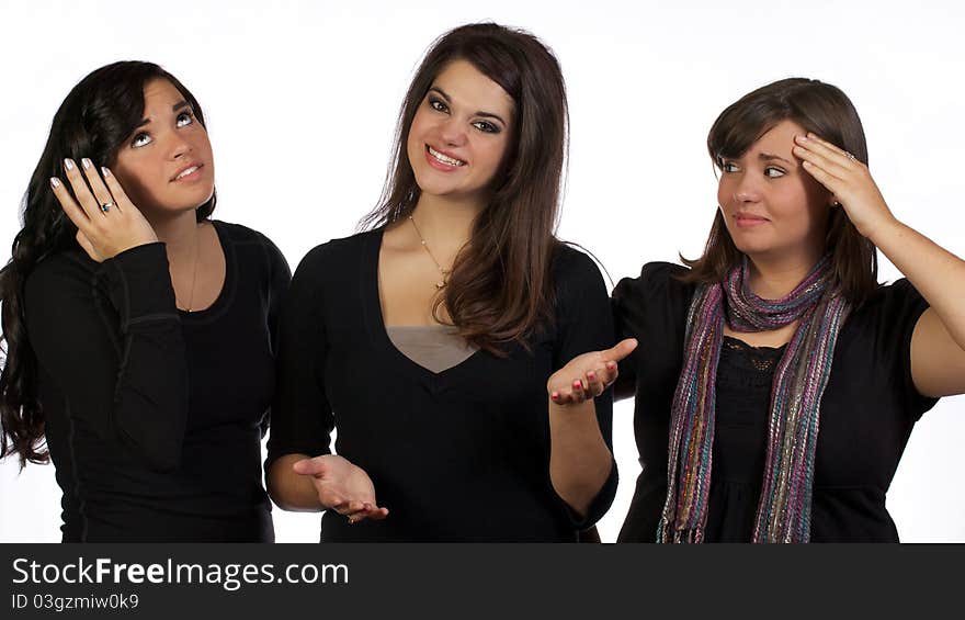 Two young sisters looking in dis-approval at their other sister. Two young sisters looking in dis-approval at their other sister