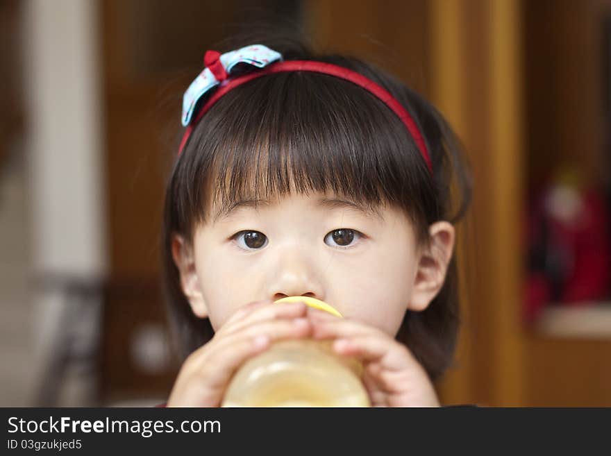 A girl is drinking her milk. A girl is drinking her milk