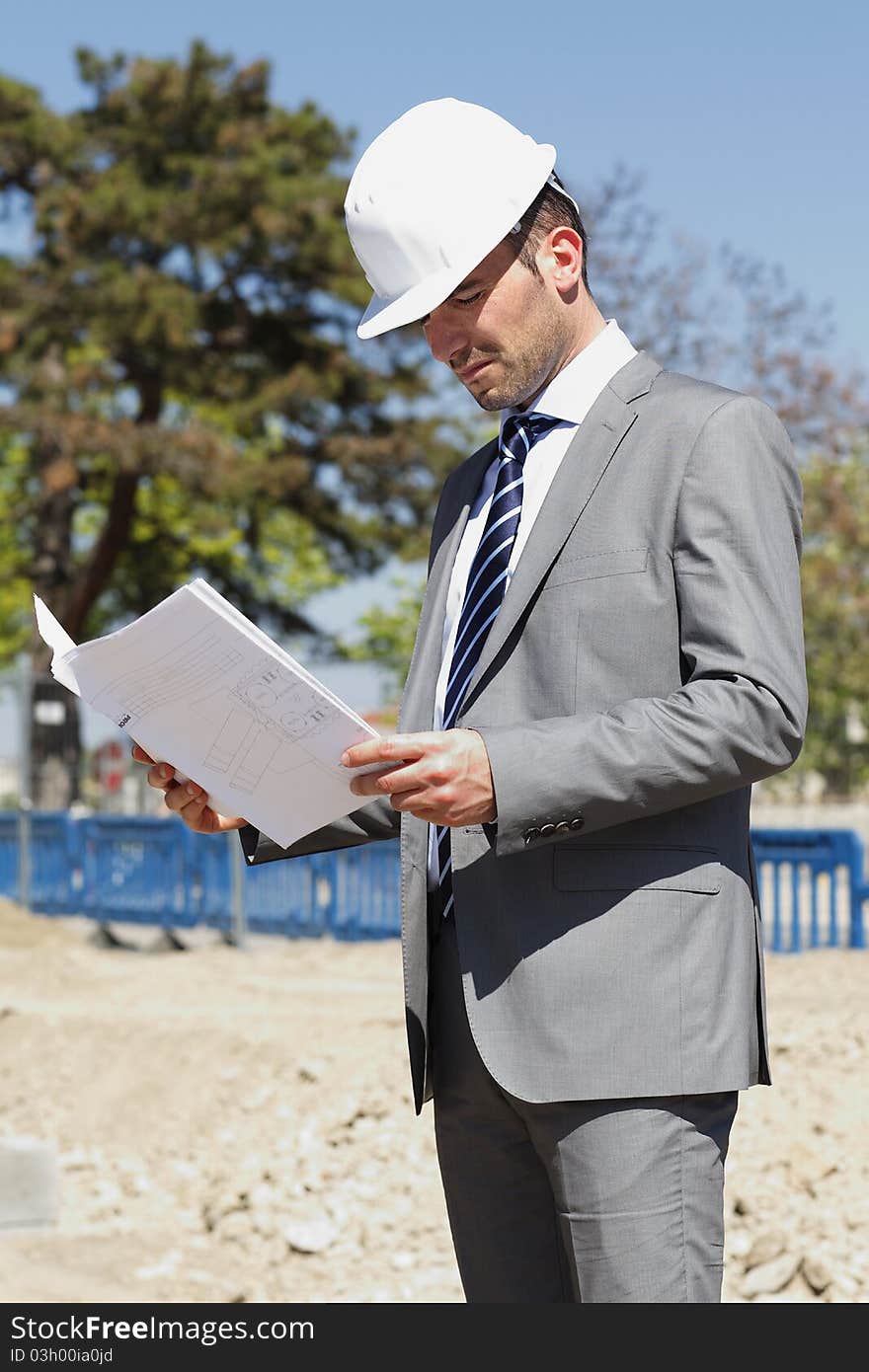 Young architect on building site in summer