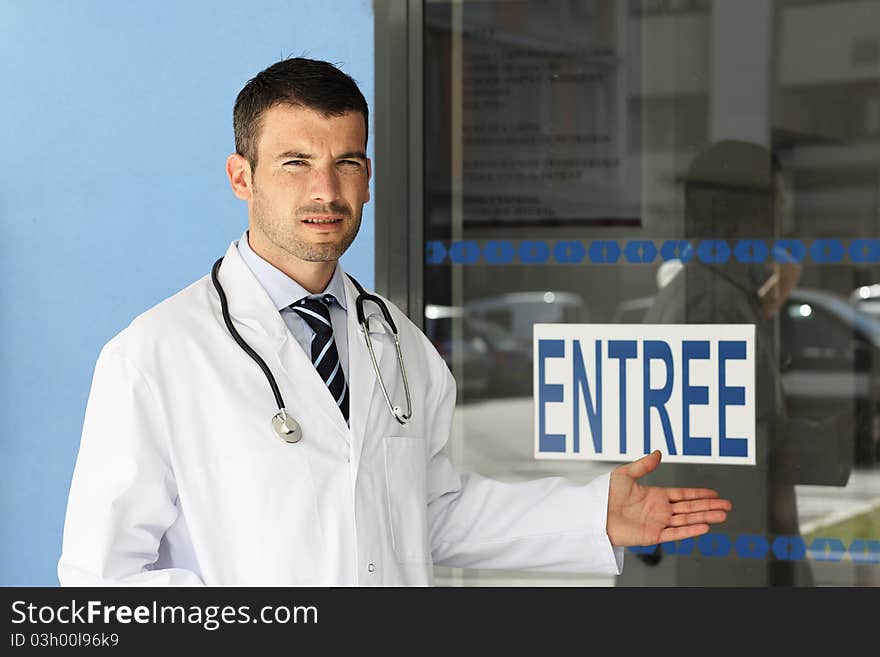 Young doctor in front of hospital entry. Young doctor in front of hospital entry