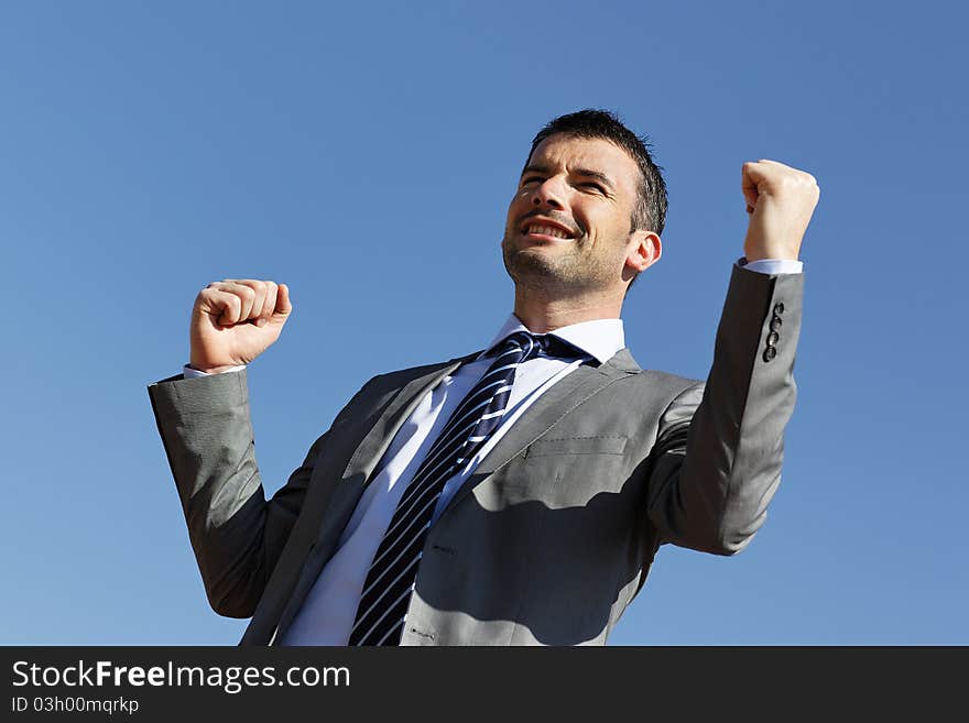 Young businessman and blue sky in summer. Young businessman and blue sky in summer