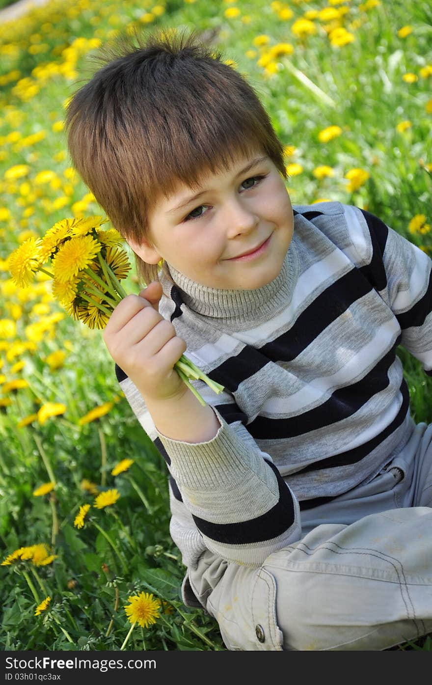 A boy with a bouquet of dandelions