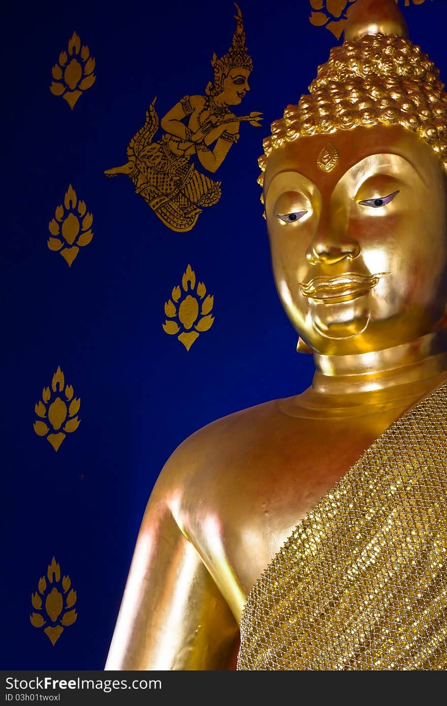 Golden Buddhism's statue with Thai art design on the wall. Golden Buddhism's statue with Thai art design on the wall