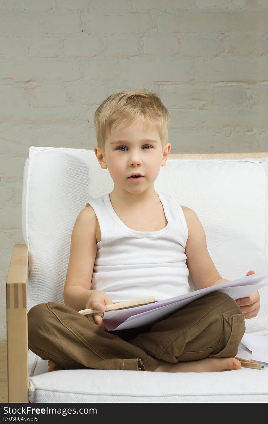 Cute blond preschooler boy drawing. Cute blond preschooler boy drawing