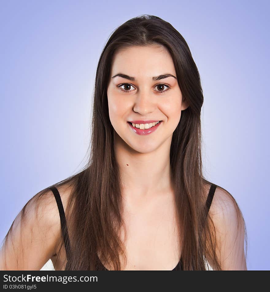 Beautiful girl posing in studio over blue background