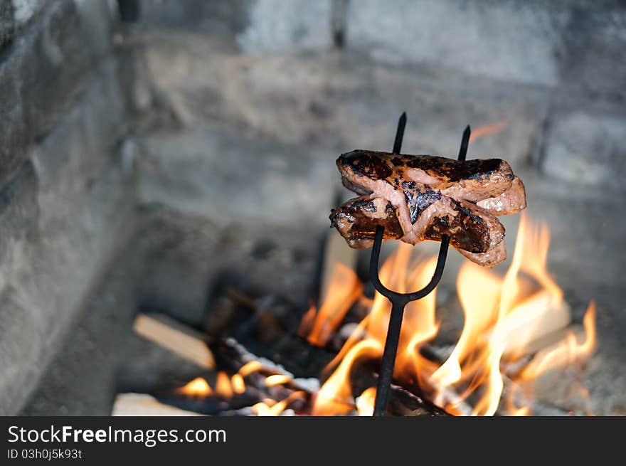 Sausage roasted over a fire in the fireplace. Sausage roasted over a fire in the fireplace