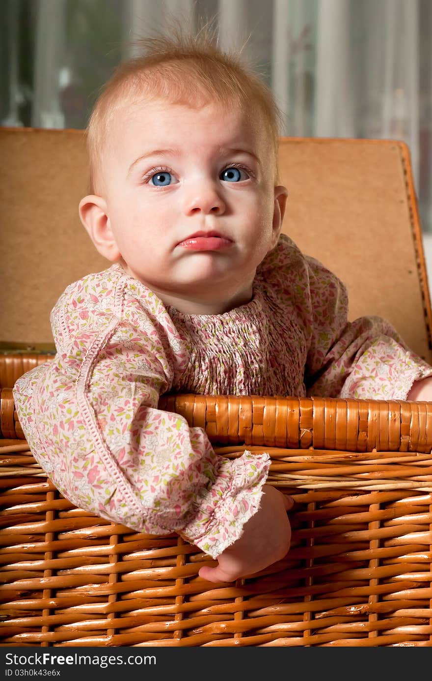 Closeup portrait of little cute baby girl in basket. Closeup portrait of little cute baby girl in basket