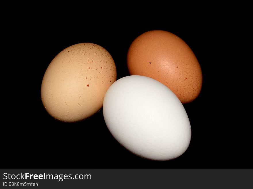 Three eggs on black background