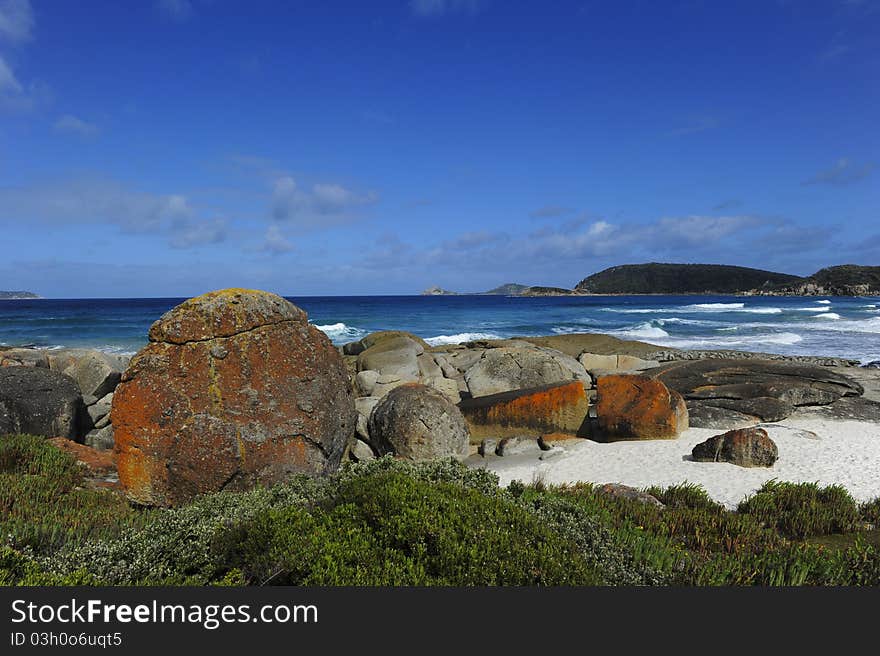 Big rusty coloured pebbles on a beautiful and remote beach at the Southern Ocean, Victoria, Australia. Big rusty coloured pebbles on a beautiful and remote beach at the Southern Ocean, Victoria, Australia.