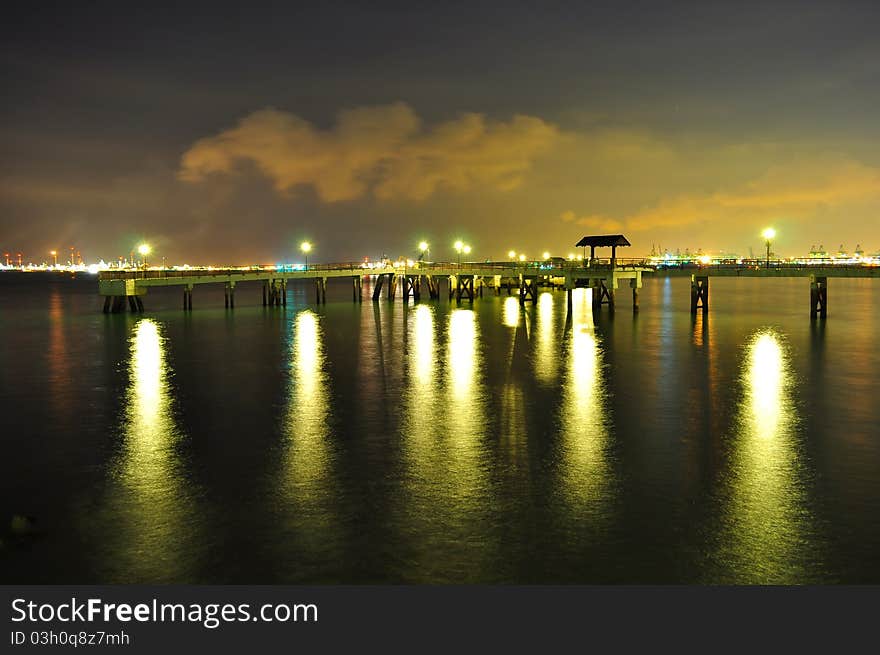 End of Labrador Park Jetty (Singapore) with lights reflection on the water, by night. End of Labrador Park Jetty (Singapore) with lights reflection on the water, by night