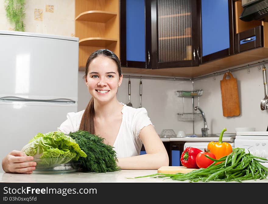 Young beautiful caucasian woman in the kitchen