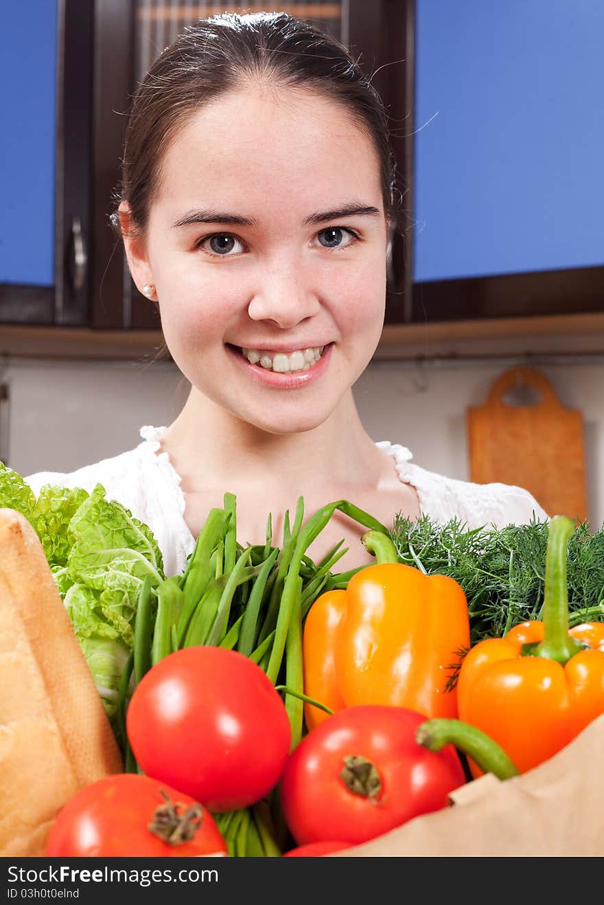 Young beautiful caucasian woman in the kitchen