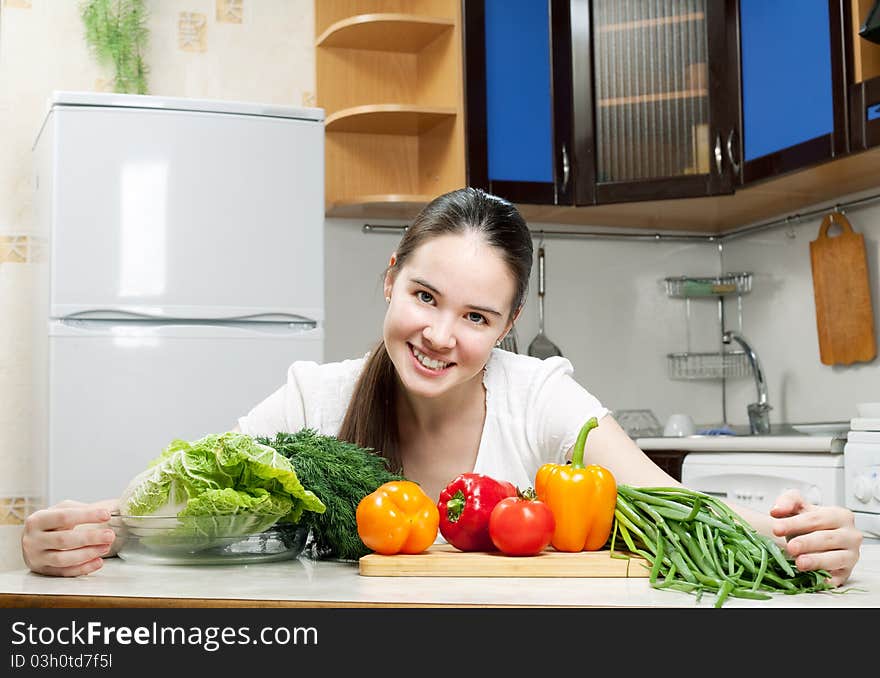 Young beautiful caucasian woman in the kitchen