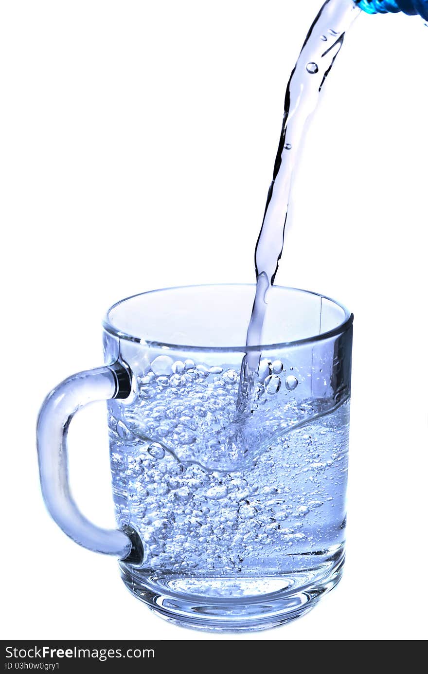 pouring water in a glass isolated against white background. pouring water in a glass isolated against white background