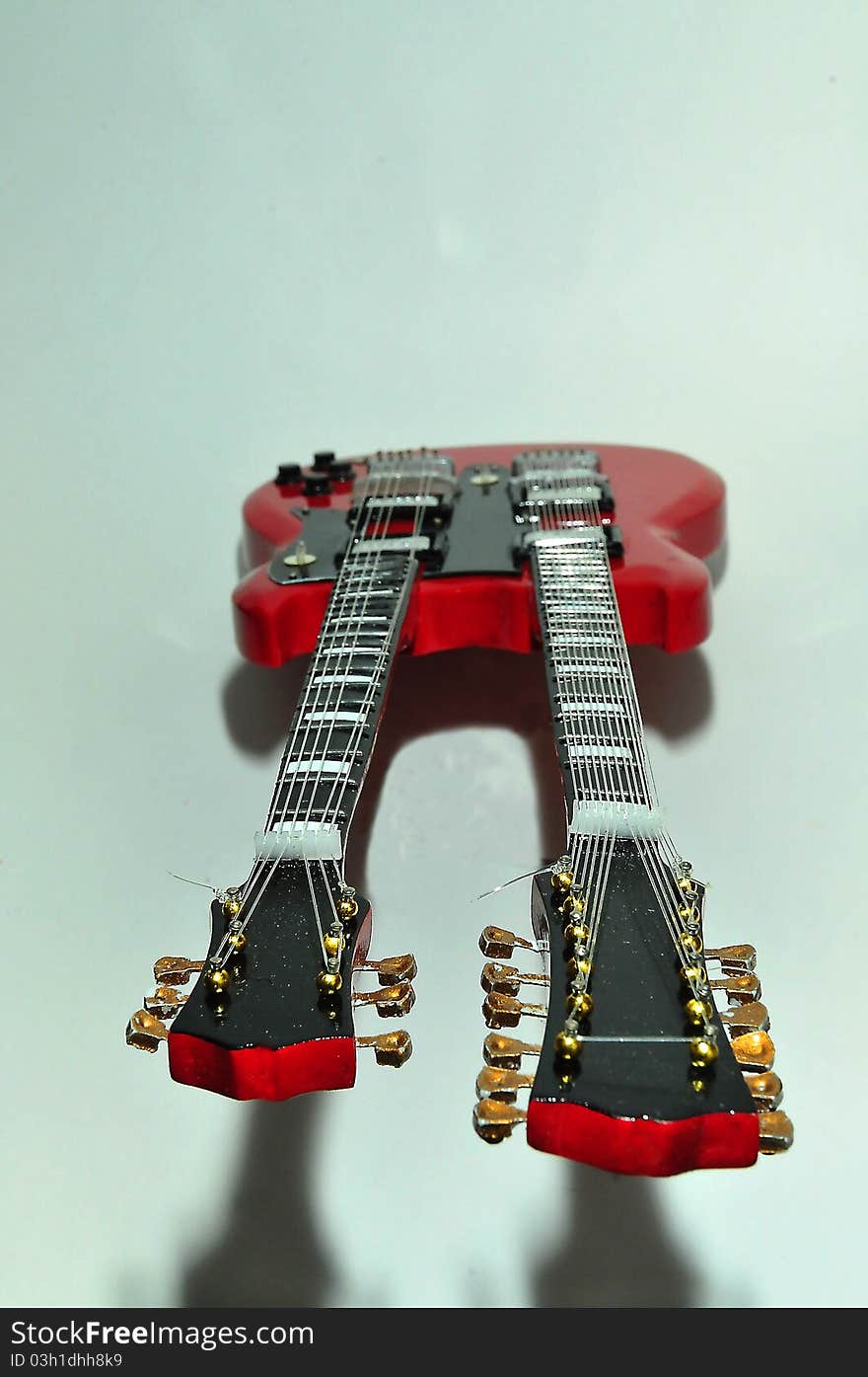 A red guitar on the white background. A red guitar on the white background