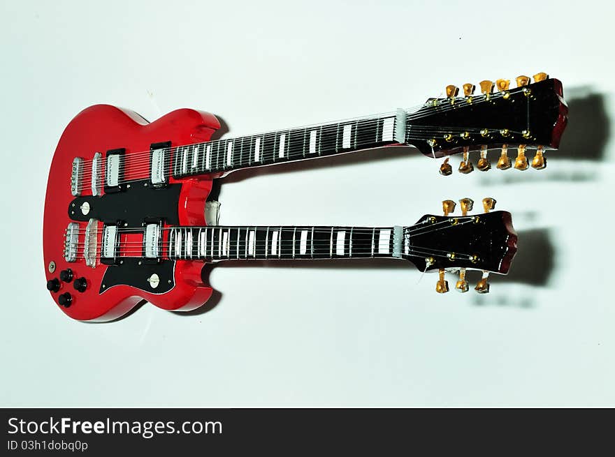 A red guitar on the white background. A red guitar on the white background