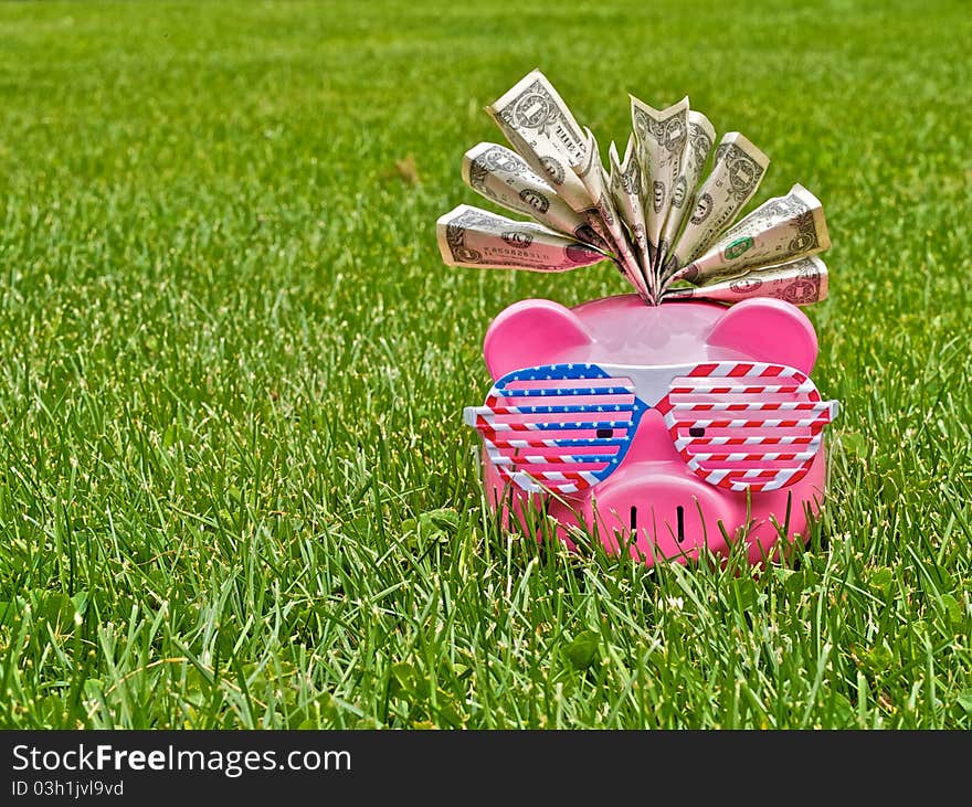 Piggy bank on the field of grass. Piggy bank on the field of grass