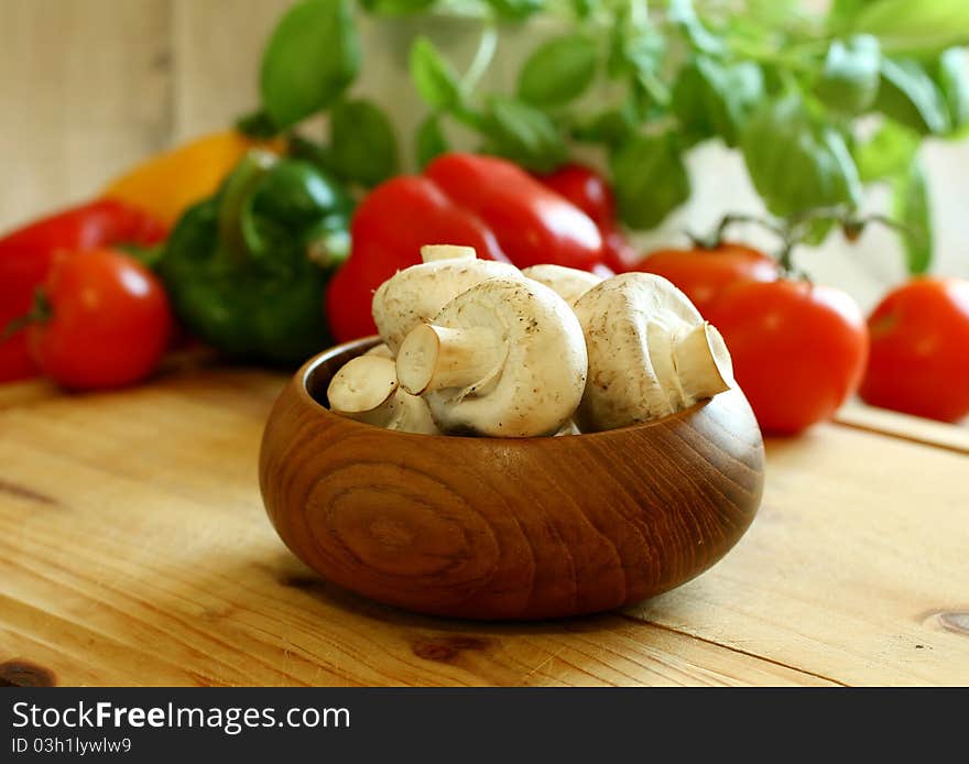 Fresh mushrooms in wooden bowl