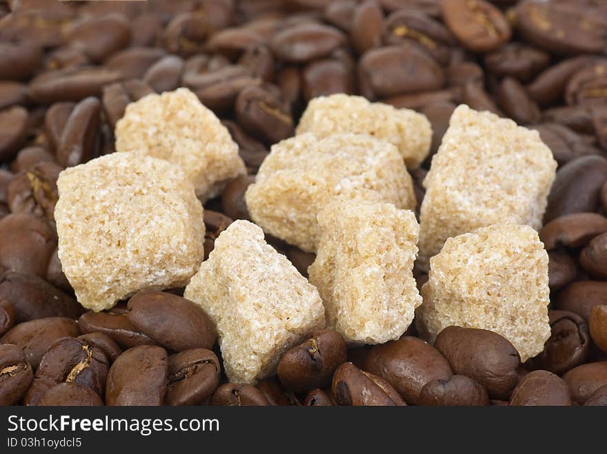 Few pieces of brown sugar and coffee beans