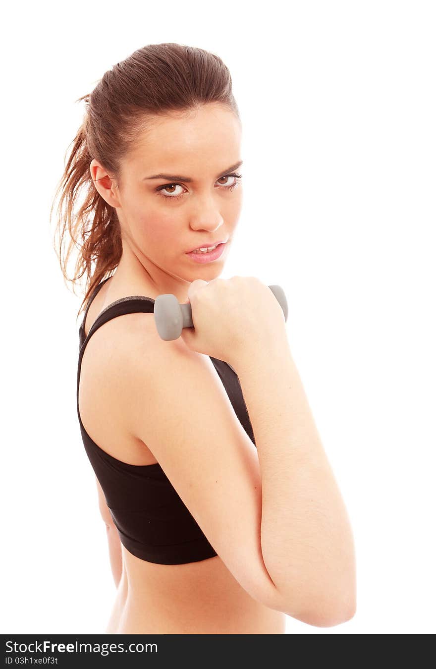 A young female dressed in gym clothes performing an arm curl exercise on isolated white background