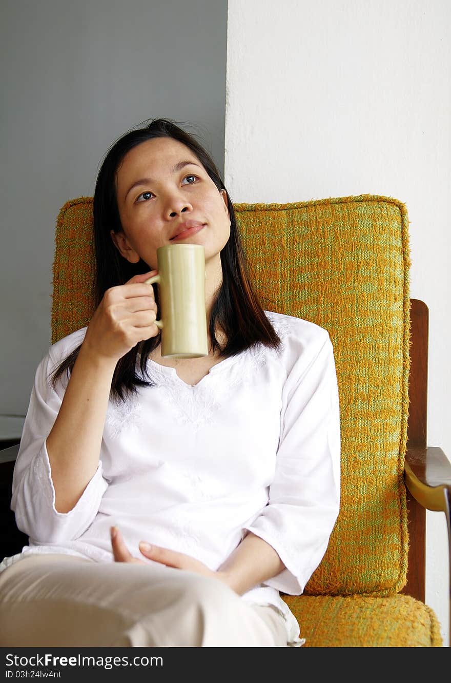 Young woman drinking at cafe