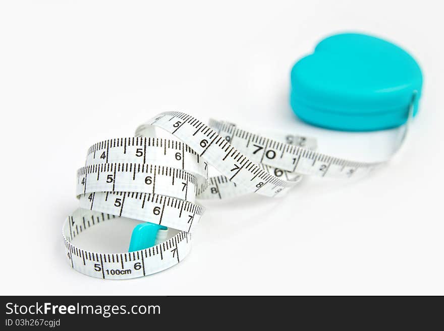 Measuring tape in heart roll isolated on white background