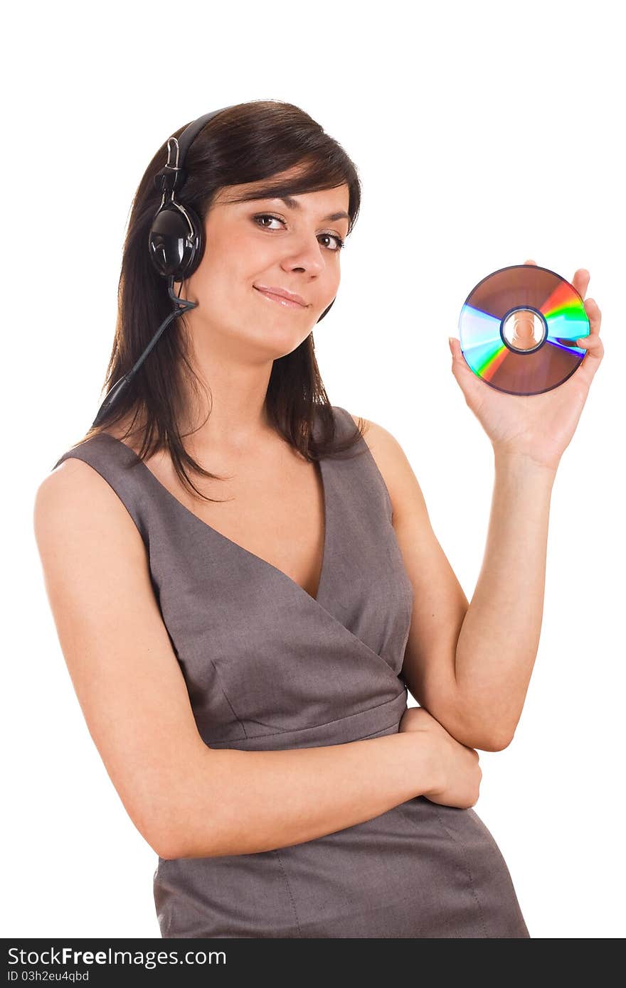 Pretty young lady listening to music and holding CD. Isolated on white background. Pretty young lady listening to music and holding CD. Isolated on white background