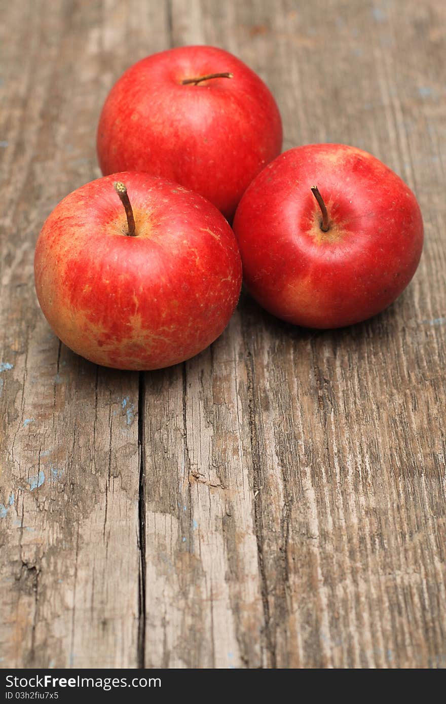 Red ripe apple on old wooden background