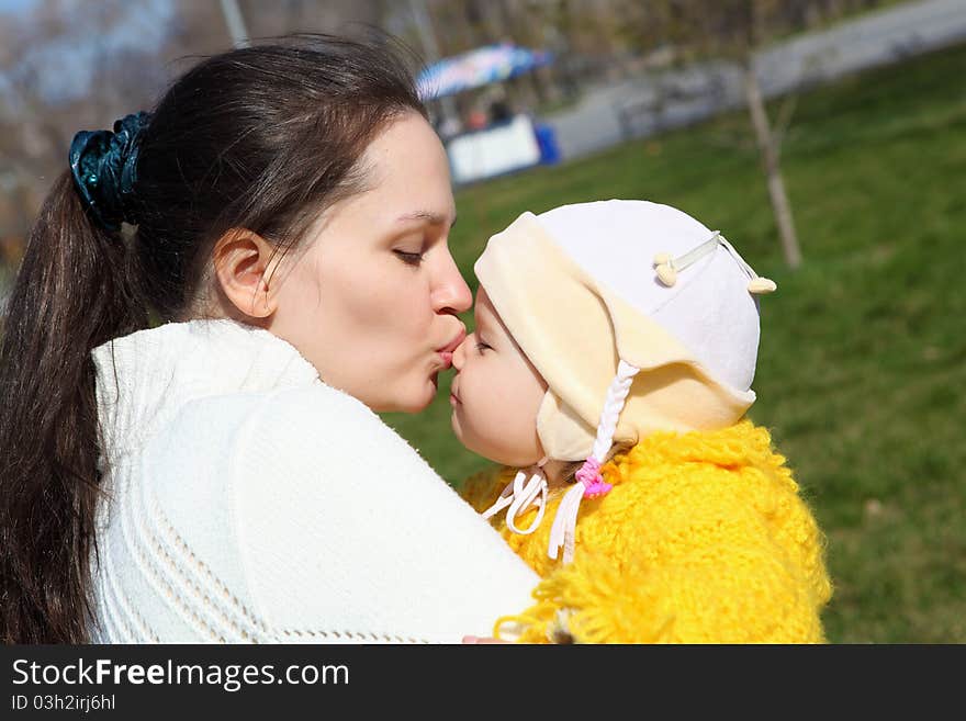 Little girl with her mother in spring park