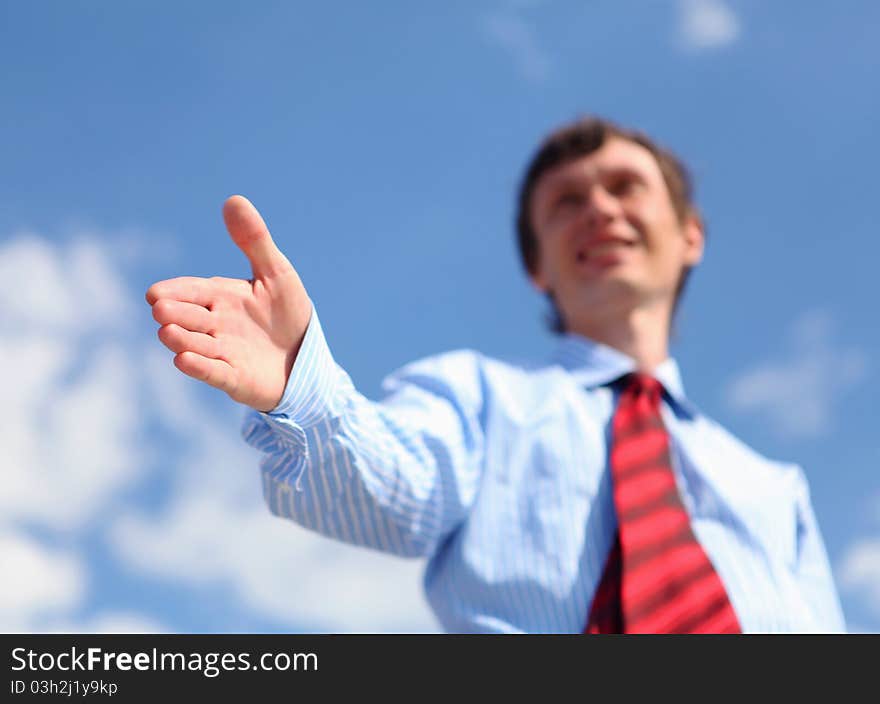 Young businessman in a blue shirt and red tie