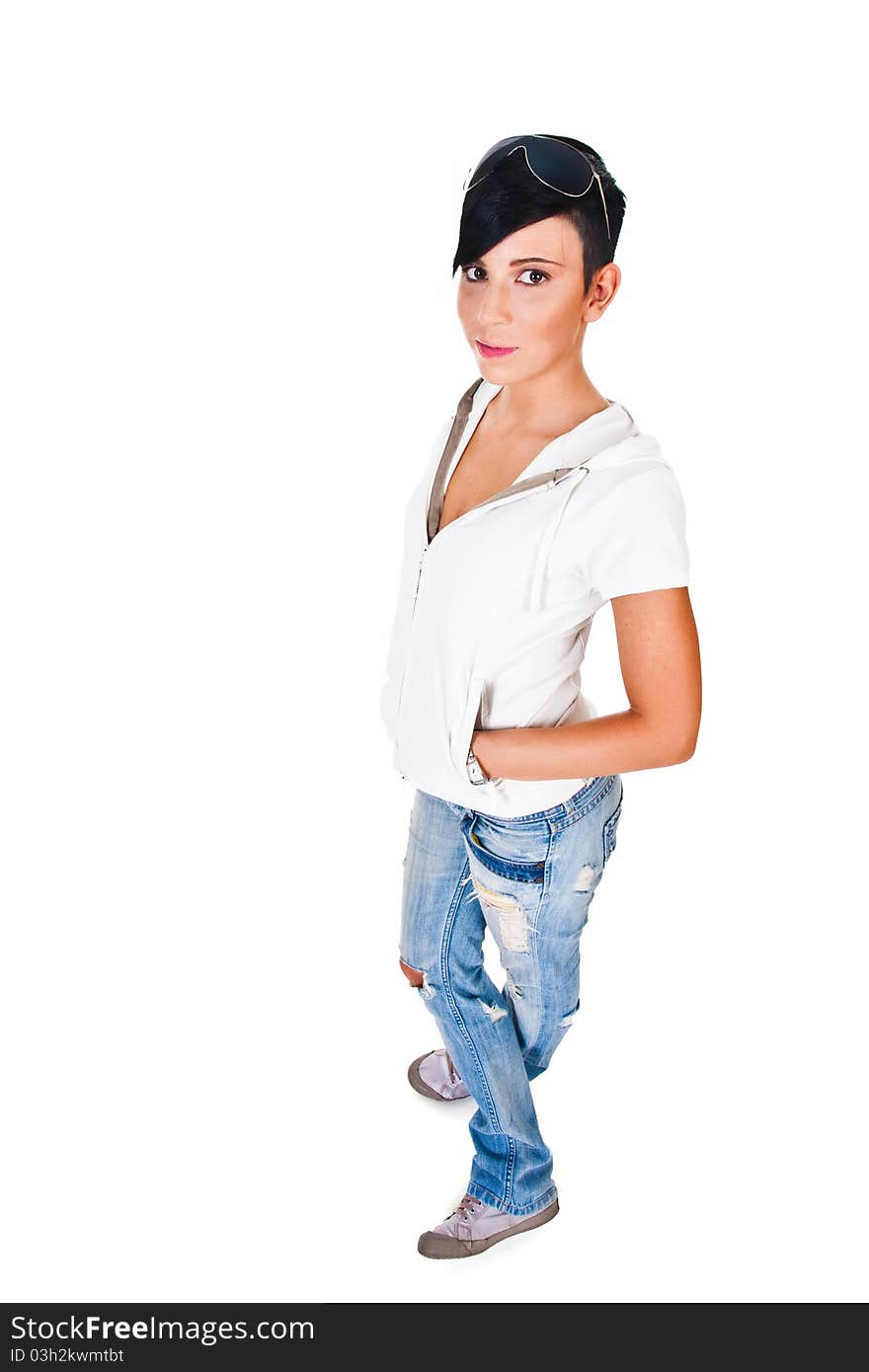 Beautiful short haired young Caucasian woman in blue jeans, over white background