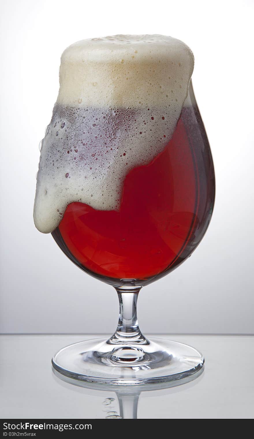 Bubbling red beer in full glass. Bubbling red beer in full glass