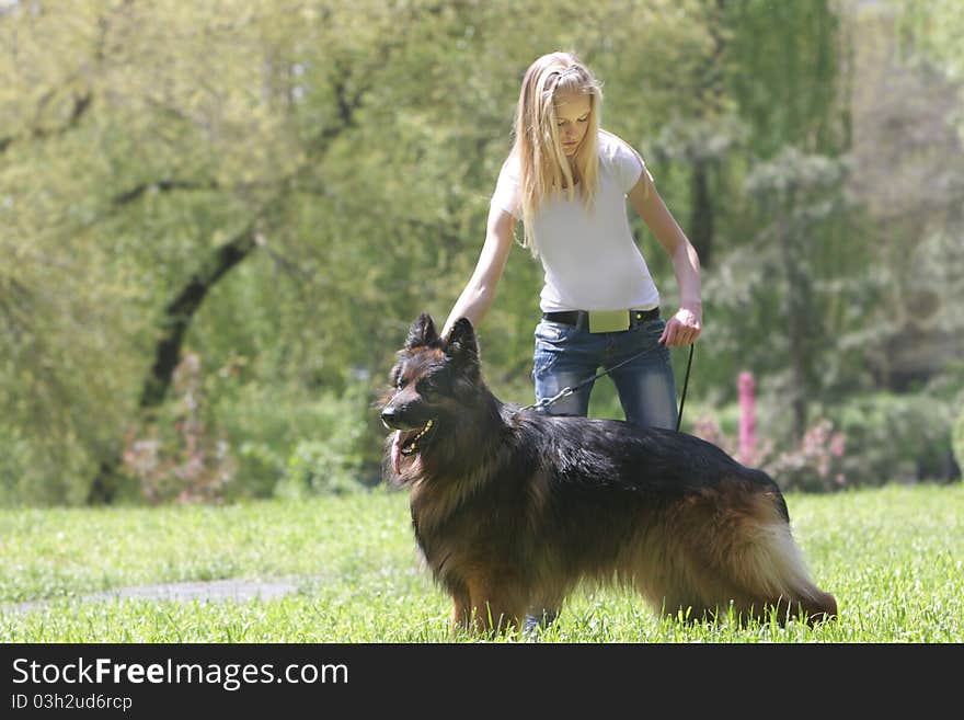 Young woman with dog on natural background