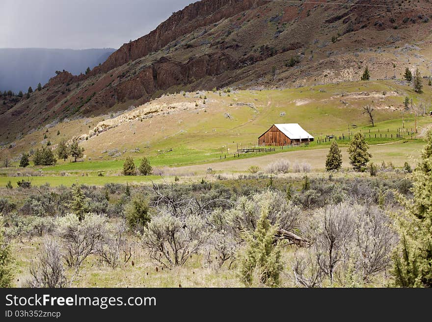 Barn at base of mountain.