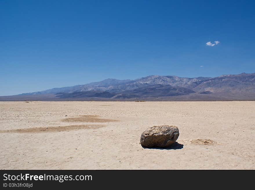 A lone stone sits on the empty, desolate floor of Death Valley National Park.