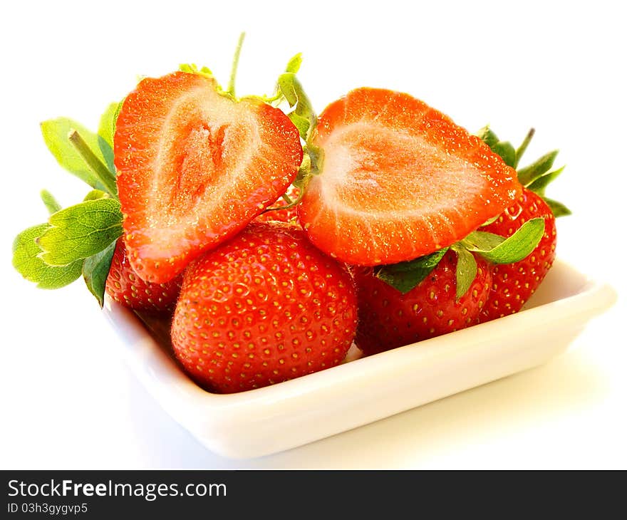 Strawberry fruit, on white plate isolated towards white background