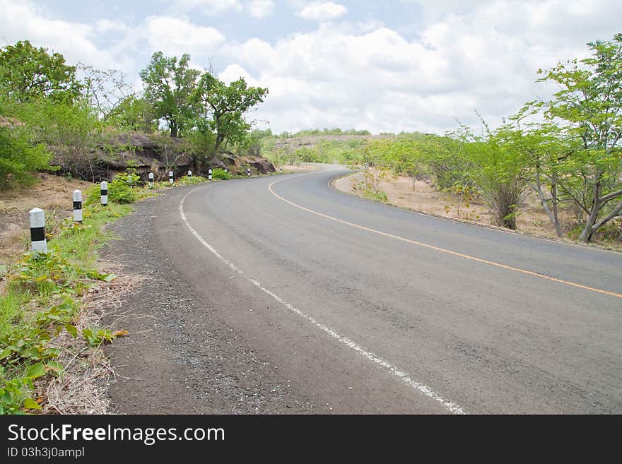 Road beside Mountain and blue sky