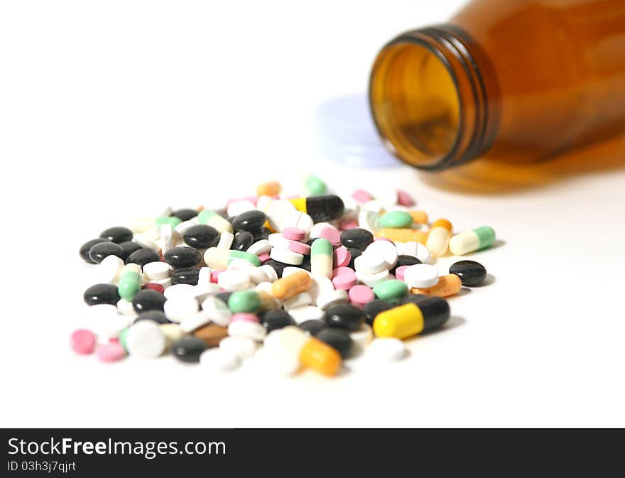 Pills and capsules with open bottle