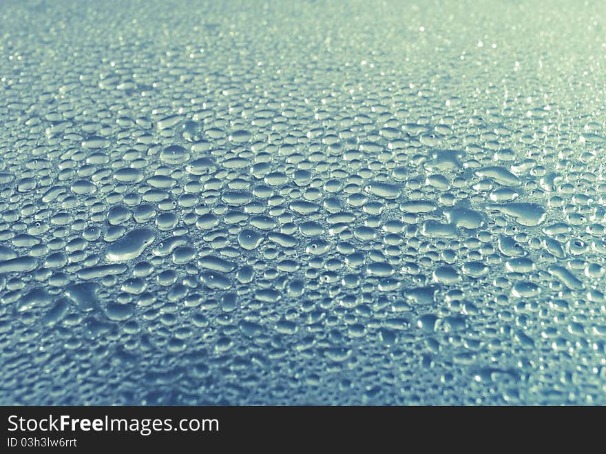 Water droplets on smooth glass surface