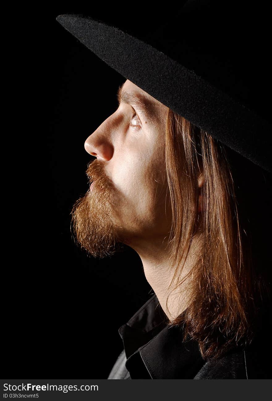 Portrait of man in hat, looking up, profile