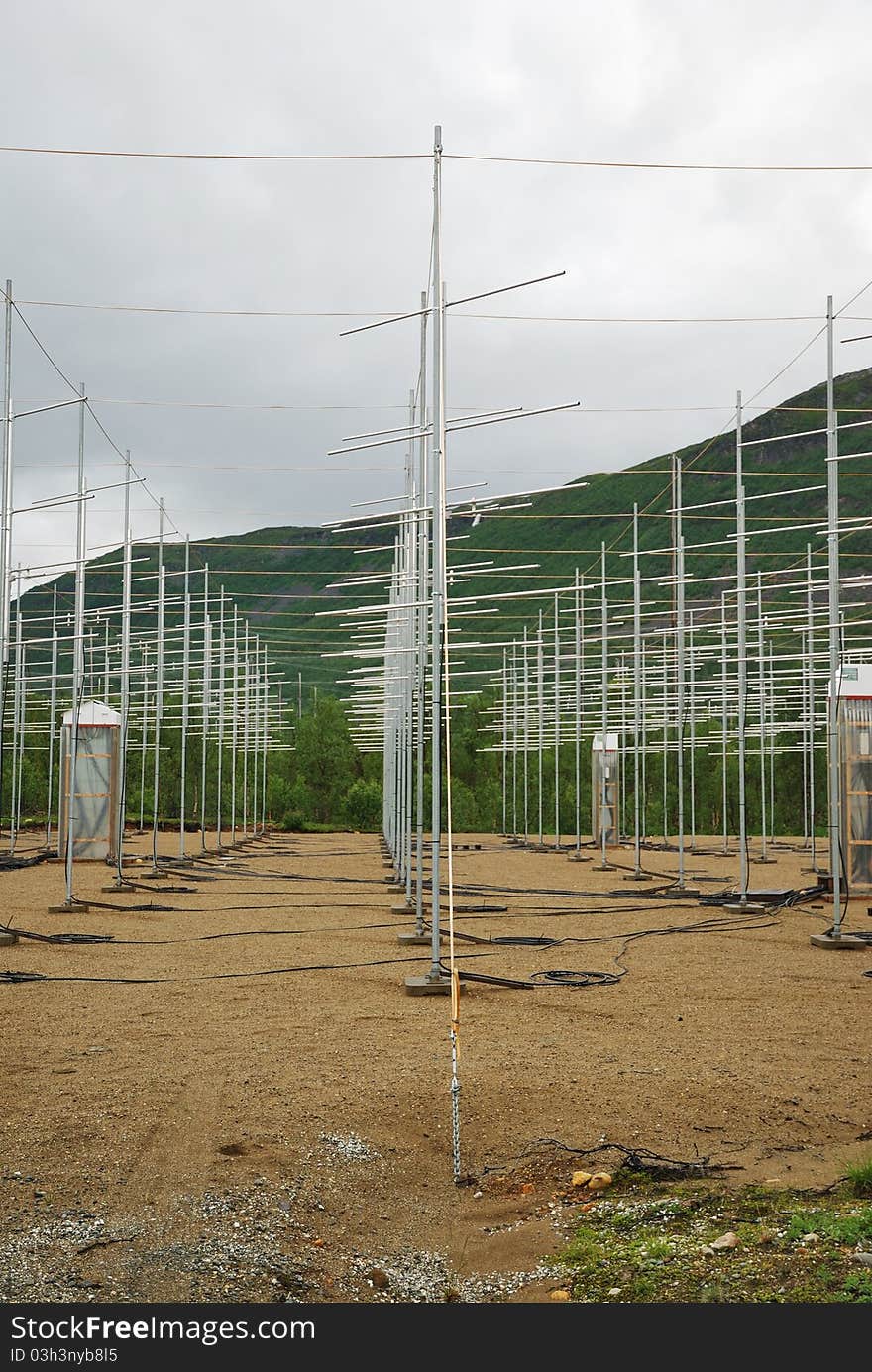 Antenna field is situated under green mountain. The sky is overcast. Antenna field is situated under green mountain. The sky is overcast.