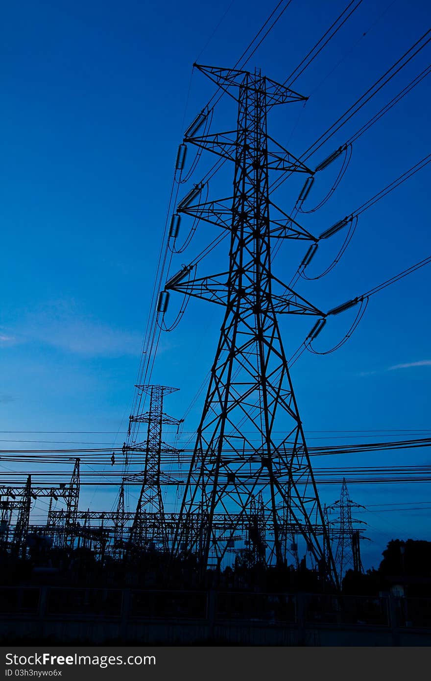 High voltage electricity pillars and blue sky before sunrise