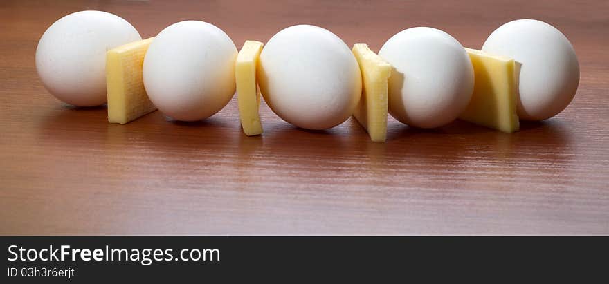 Cheese and eggs a semicircle on a table